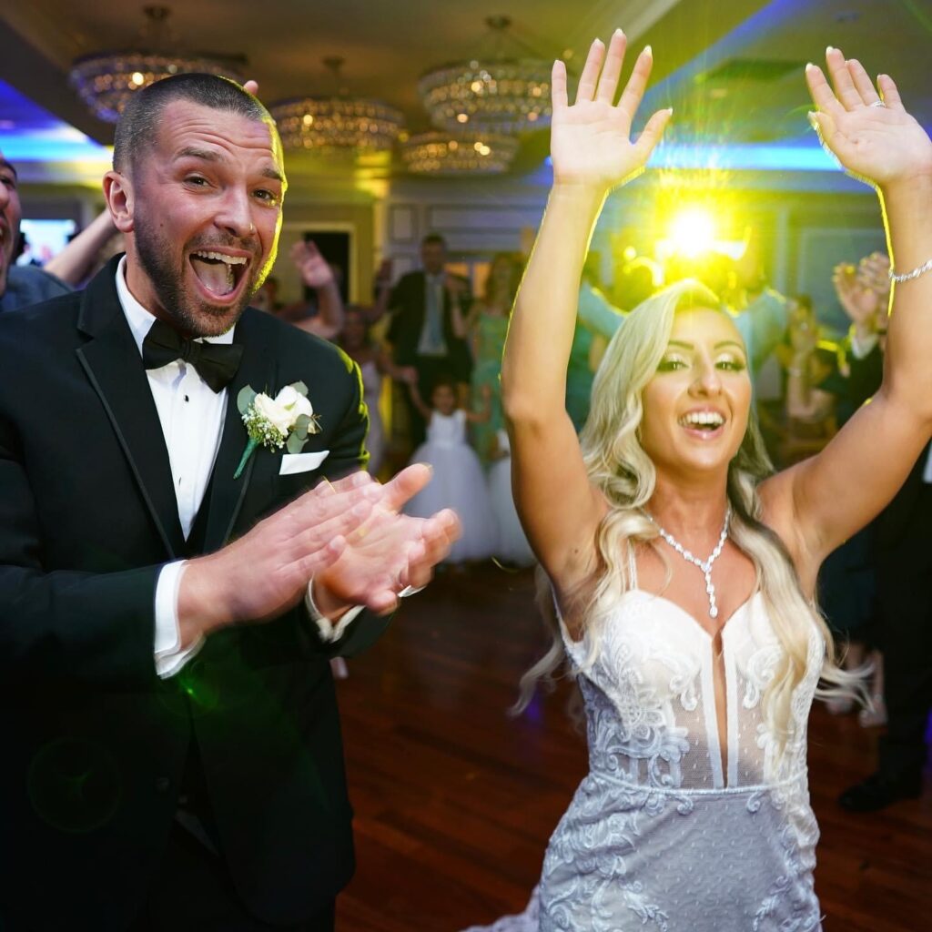 Bride and groom enjoying a packed wedding dance floor all night